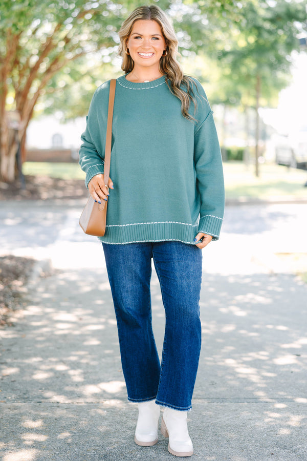 Plus Size green knit crewneck sweater with white contrast stitching on the neckline and ribbed hem.