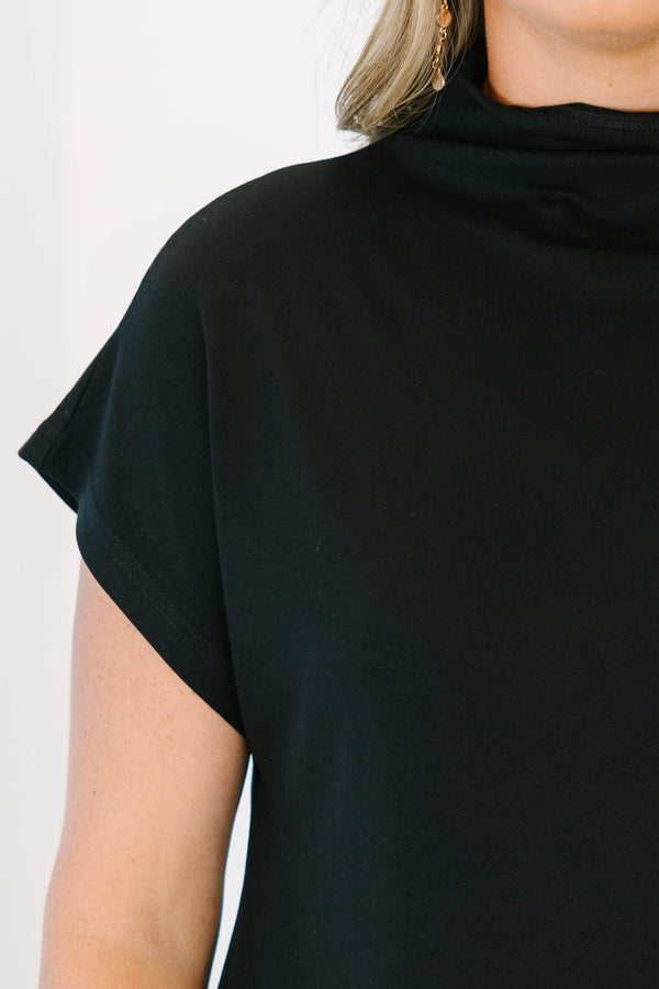 Plus Size black short sleeve mock neck top with a relaxed fit and side slits.