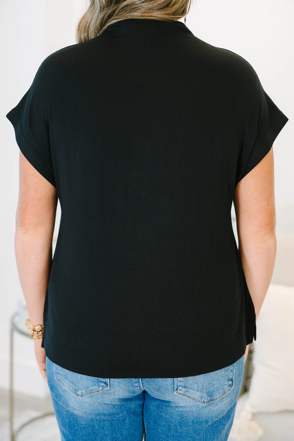 Plus Size black short sleeve mock neck top with a relaxed fit and side slits.