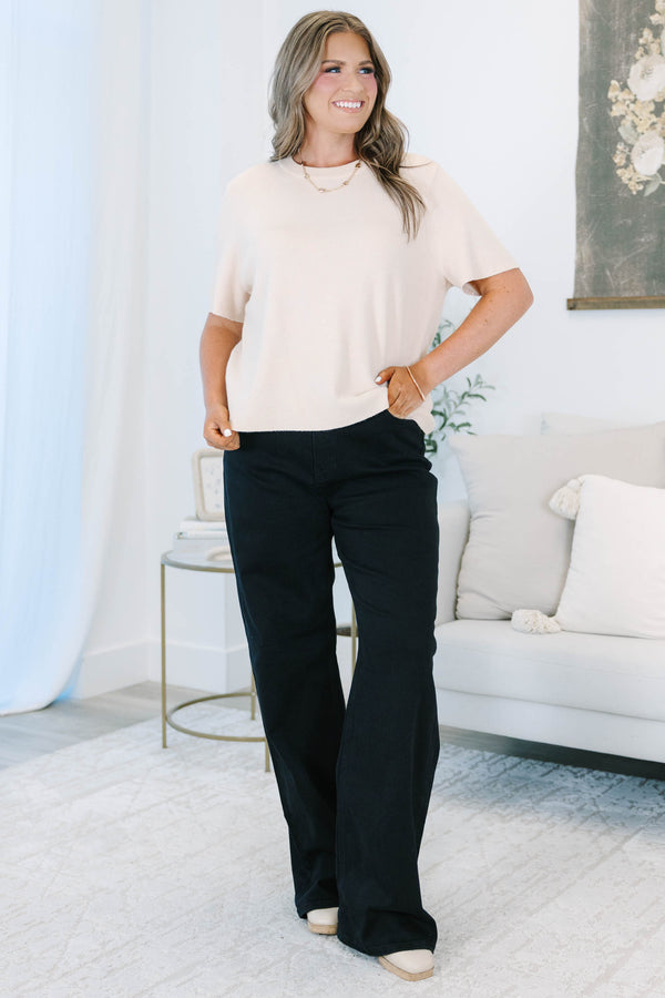 Plus size black wide leg jeans in a stretchy, high-waisted fit for a confident, feminine look.