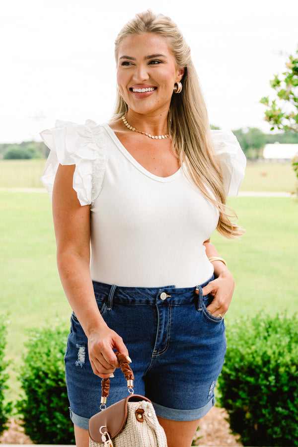 Chic Soul plus size clothing, medium wash denim shorts with distressing near right pocket and left leg cuff