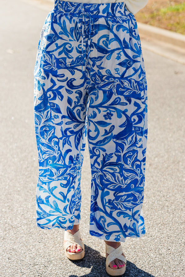 Chic Soul plus size clothing, wide-leg cropped flowy blue pants with an elastic waistband and waist tie with a blue and white tropical floral pattern