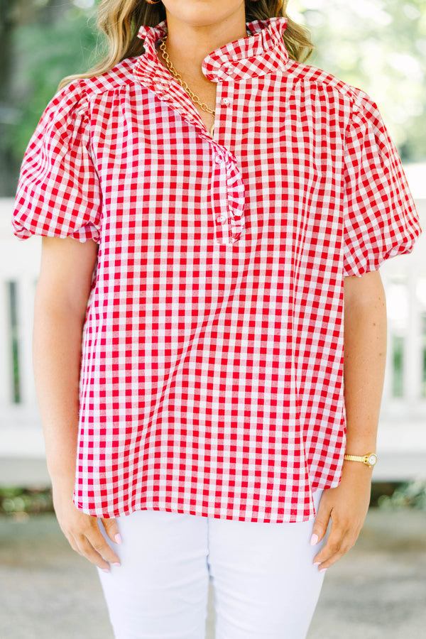 Plus size red and white gingham top with ruffle collar and short puff sleeves.