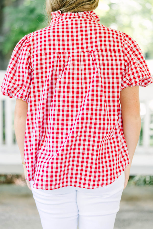 Plus size red and white gingham top with ruffle collar and short puff sleeves.