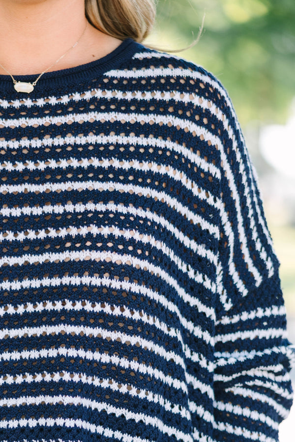 Plus Size navy and white striped knit sweater with a crew neckline and long sleeves.