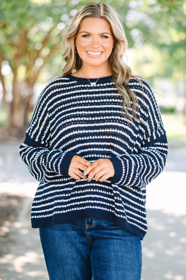 Plus Size navy and white striped knit sweater with a crew neckline and long sleeves.