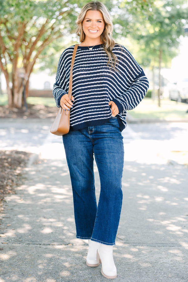 Plus Size navy and white striped knit sweater with a crew neckline and long sleeves.