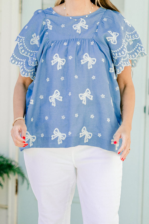 Chic Soul plus size clothing, denim top with flutter sleeves and white embroidered bows and flowers details throughout the top  
