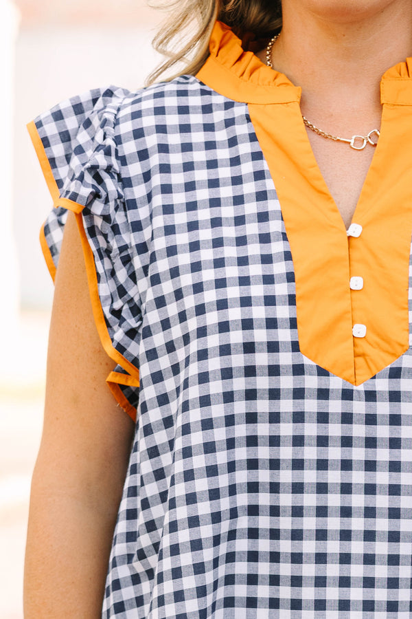 Plus Size navy and white gingham maxi dress with orange ruffle sleeves and a buttoned orange collar.