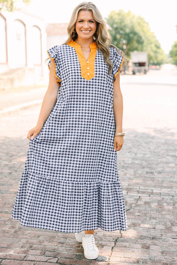Plus Size navy and white gingham maxi dress with orange ruffle sleeves and a buttoned orange collar.