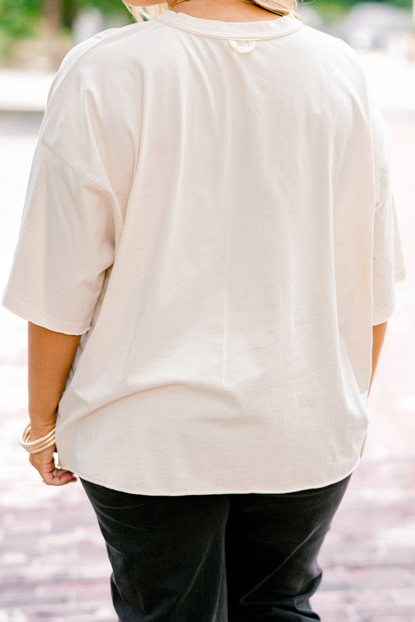 Chic Soul plus size clothing, off white, half sleeve boxy oversized tee with Halloween themed stamps on the front in shades of orange with designs like candy corn, ghosts, pumpkins, witches, and skulls