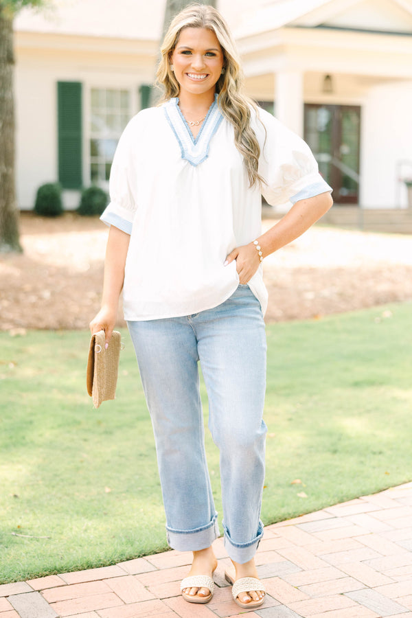 Plus Size white v-neck blouse with blue striped contrast trim, jacquard detail, and puff sleeves.