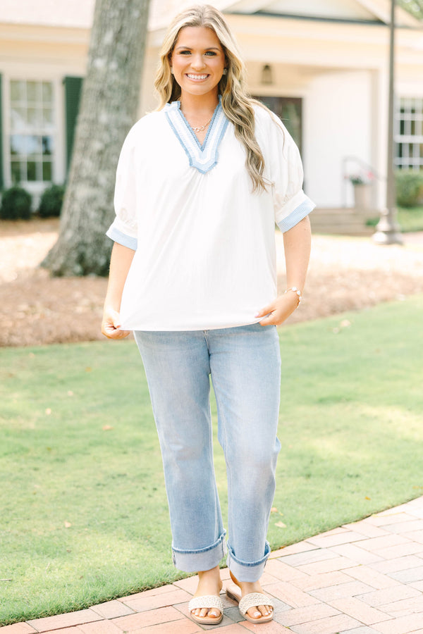 Plus Size white v-neck blouse with blue striped contrast trim, jacquard detail, and puff sleeves.
