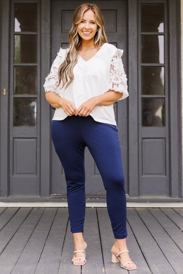 Plus Size navy cropped pants with a wide waistband and slim, stretchy fit.