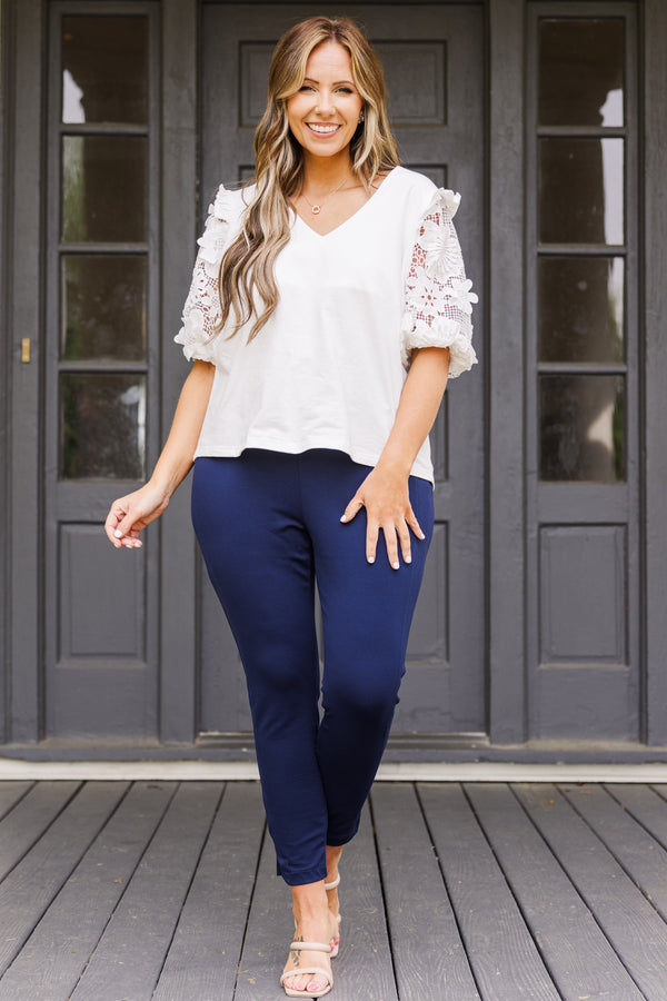 Plus Size navy cropped pants with a wide waistband and slim, stretchy fit.
