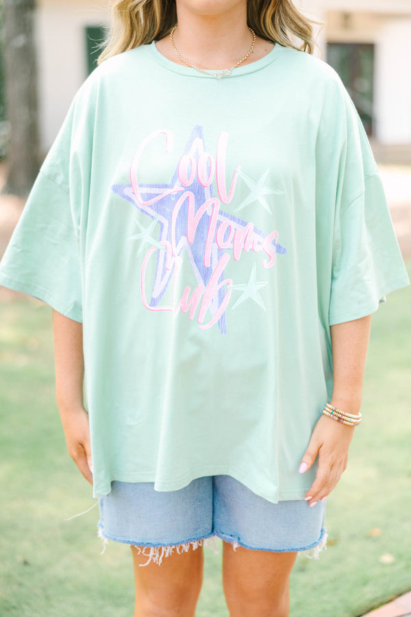 Plus size light sage boyfriend tee with 'Cool Moms Club' graphic and a relaxed, flowy fit.