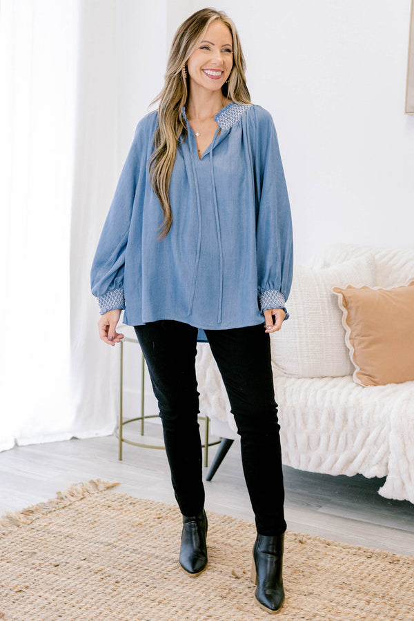 Chic soul plus size clothing, long sleeve flowy denim blouse with white stitching detailing around the collar and cuff of the sleeves, with 2 drawstrings at the collar
