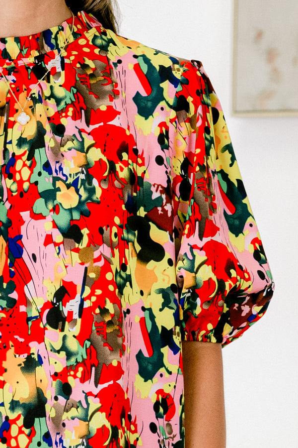 Chic Soul plus size clothing, abstract paint splatter patterned multicolor blouse including red and light pink and yellow and black plus pleated mock neck and short-bubble sleeves