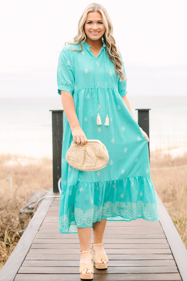 Chic Soul plus size clothing, turquoise tiered maxi dress with short sleeves that have a cuff at the bottom as well as an abstract block pattern throughout the dress and tassels hanging from the v-neckline 
