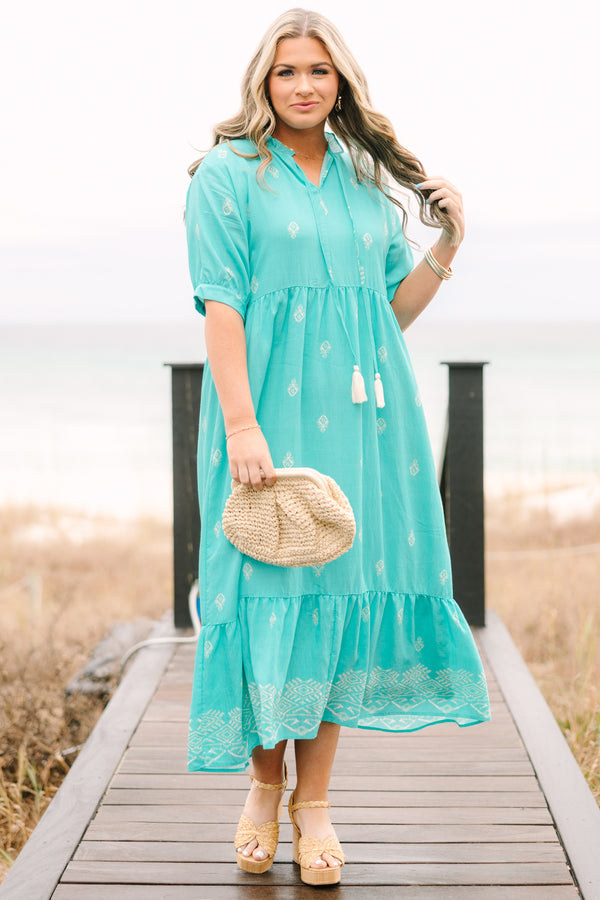 Chic Soul plus size clothing, turquoise tiered maxi dress with short sleeves that have a cuff at the bottom as well as an abstract block pattern throughout the dress and tassels hanging from the v-neckline 

