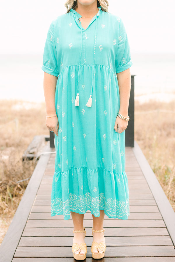 Chic Soul plus size clothing, turquoise tiered maxi dress with short sleeves that have a cuff at the bottom as well as an abstract block pattern throughout the dress and tassels hanging from the v-neckline 
