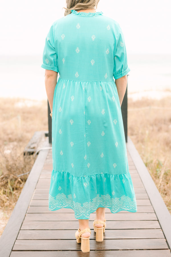 Chic Soul plus size clothing, turquoise tiered maxi dress with short sleeves that have a cuff at the bottom as well as an abstract block pattern throughout the dress and tassels hanging from the v-neckline 
