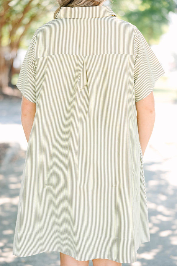 Plus size woman in a green stripe Sweet Breeze shirt dress with a flowy fit and button-down front.