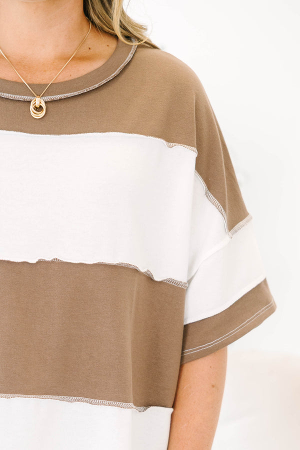 Plus size woman in a mocha and white striped oversized tee with raw edge details