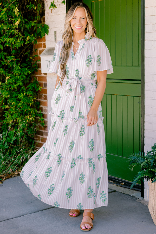 Chic Soul Plus size clothing, beige short sleeve maxi dress that has subtle stripes going down the dress and a floral green pattern as well as a bow that ties around the waist 
