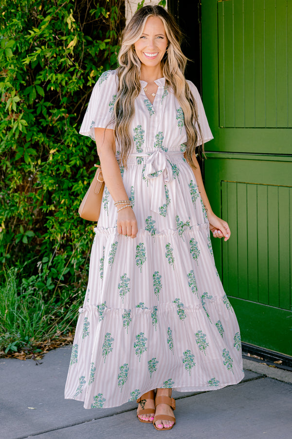Chic Soul Plus size clothing, beige short sleeve maxi dress that has subtle stripes going down the dress and a floral green pattern as well as a bow that ties around the waist 