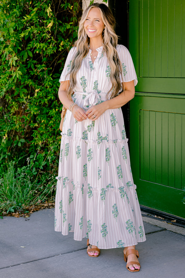 Chic Soul Plus size clothing, beige short sleeve maxi dress that has subtle stripes going down the dress and a floral green pattern as well as a bow that ties around the waist 