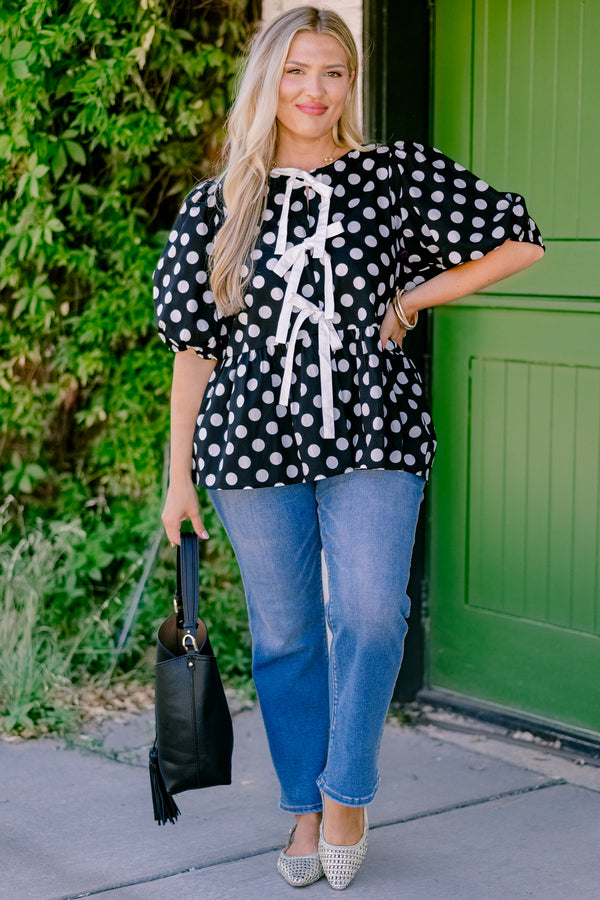 Chic Soul plus size clothing, black polka dot peplum top with bubble sleeves and there bows going down the center of the shirt