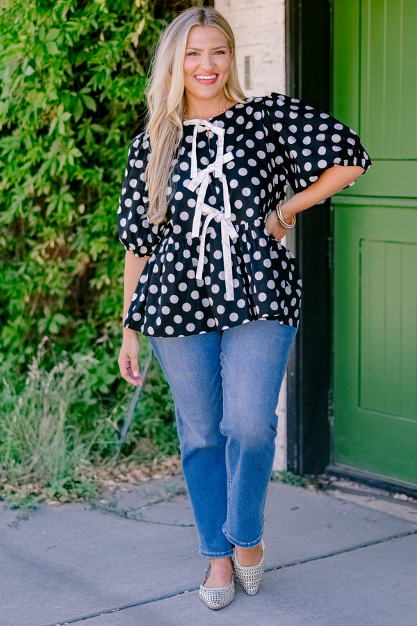 Chic Soul plus size clothing, black polka dot peplum top with bubble sleeves and there bows going down the center of the shirt