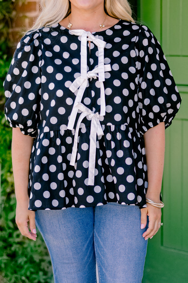 Chic Soul plus size clothing, black polka dot peplum top with bubble sleeves and there bows going down the center of the shirt