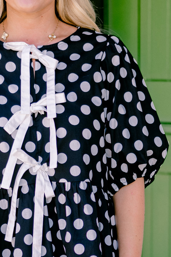 Chic Soul plus size clothing, black polka dot peplum top with bubble sleeves and there bows going down the center of the shirt