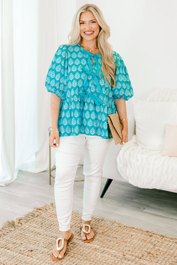 Chic Soul Plus size clothing, bright blue top with bubble sleeves a block pattern and the bows going down the center of the shirt 