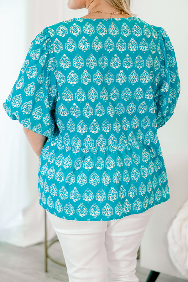 Chic Soul Plus size clothing, bright blue top with bubble sleeves a block pattern and the bows going down the center of the shirt 