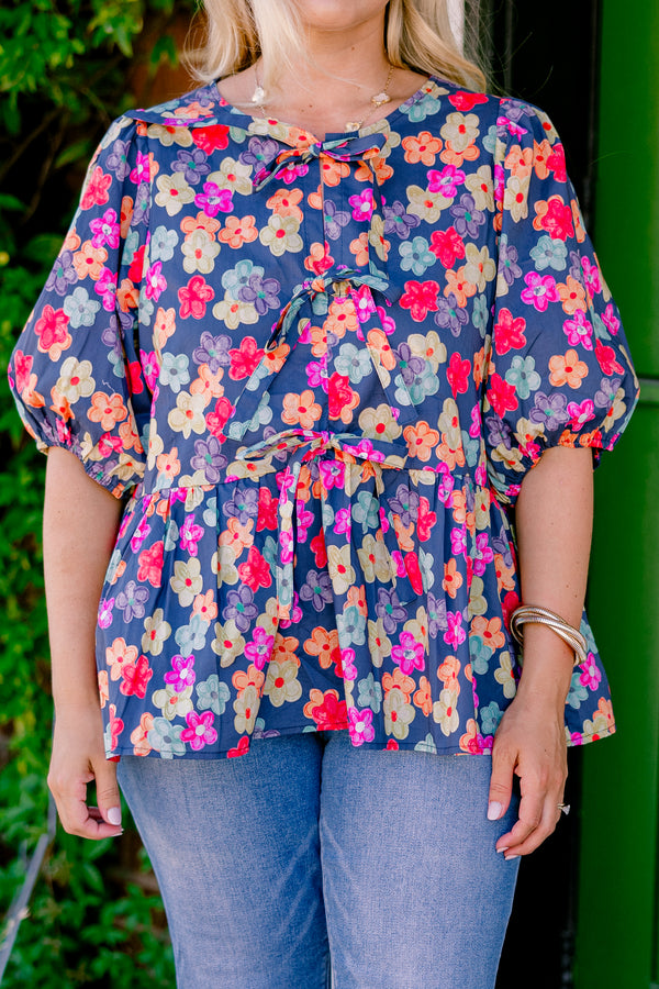 Chic Soul Plus size clothing, navy floral peplum top with bubble sleeves and three bows going down the center of the shirt 
