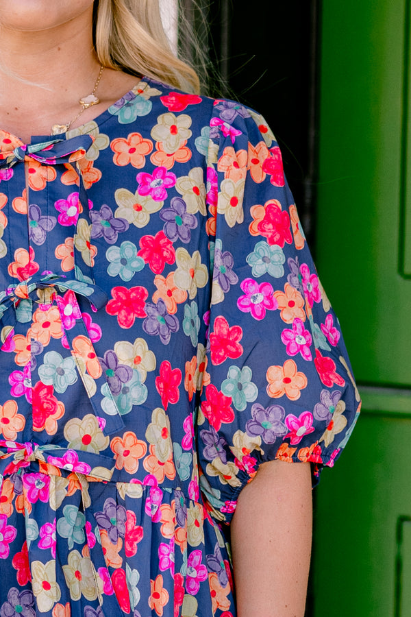 Chic Soul Plus size clothing, navy floral peplum top with bubble sleeves and three bows going down the center of the shirt 
