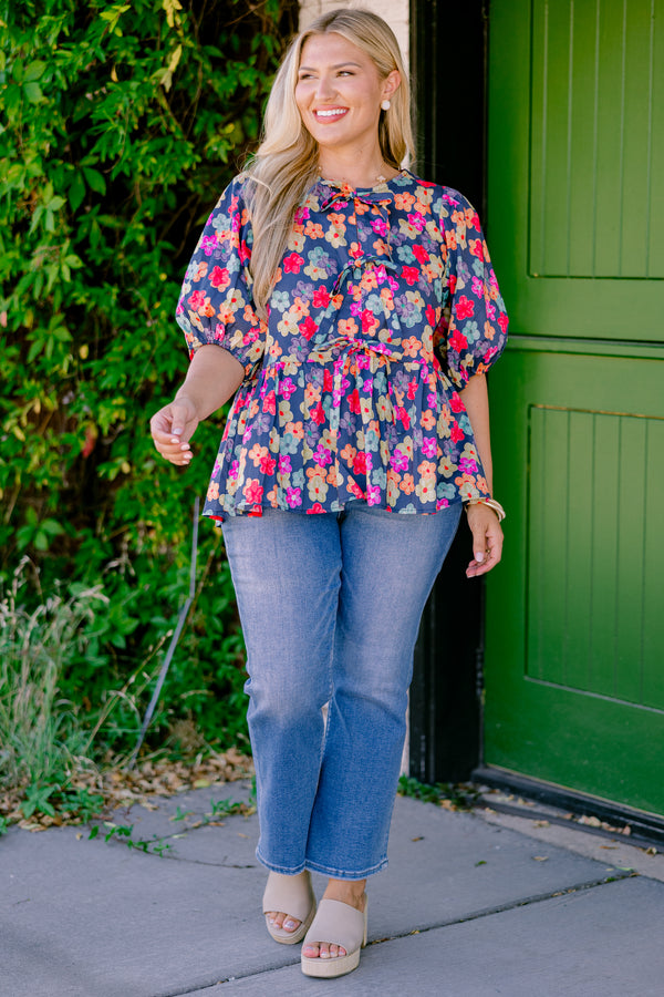 Chic Soul Plus size clothing, navy floral peplum top with bubble sleeves and three bows going down the center of the shirt 
