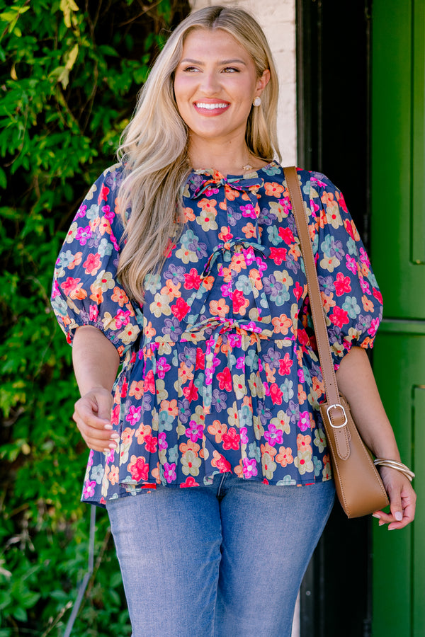 Chic Soul Plus size clothing, navy floral peplum top with bubble sleeves and three bows going down the center of the shirt 
