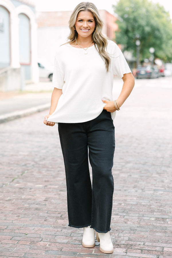 Plus Size black acid-washed wide-leg jeans with a frayed cutoff hem and a straight fit.