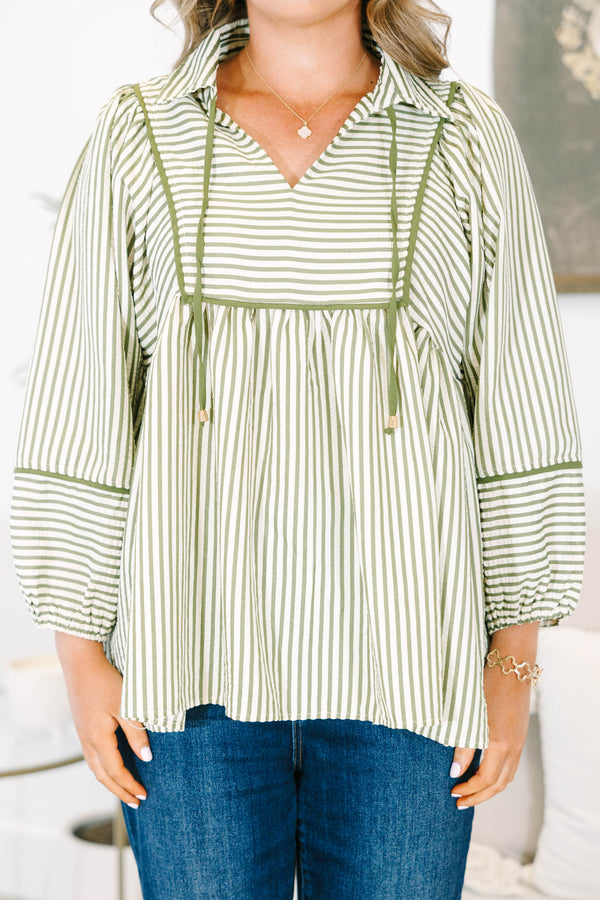 Plus size olive and white striped flowy top with long puff sleeves and a v-neckline.