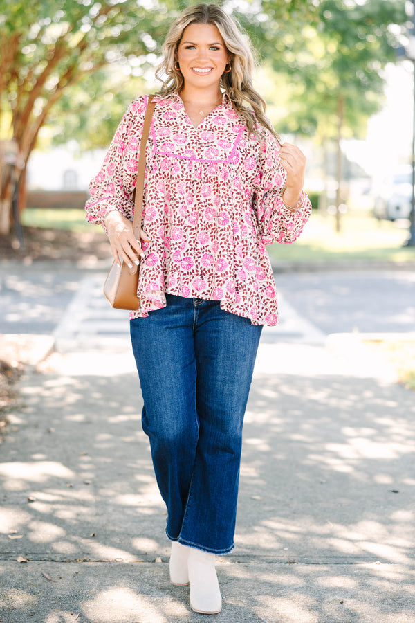 Plus size pink floral print top with a flowy fit, V-neckline, and long balloon sleeves.