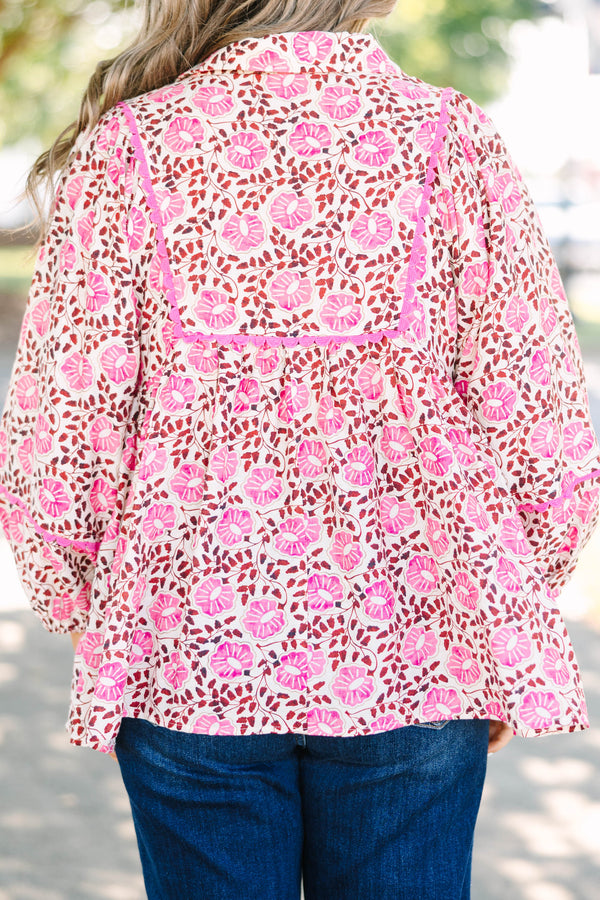 Plus size pink floral print top with a flowy fit, V-neckline, and long balloon sleeves.