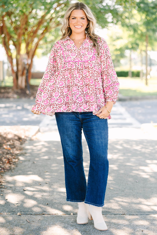 Plus size pink floral print top with a flowy fit, V-neckline, and long balloon sleeves.