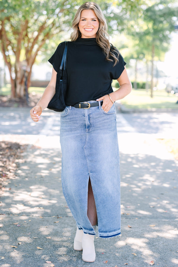 Plus size medium wash denim midi skirt with a front slit and raw hem for a confident, chic look.