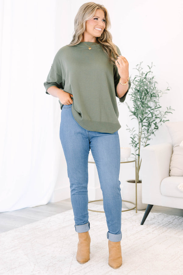 Plus size high-rise skinny jeans in denim blue with cuffed ankles and stretchy fabric.