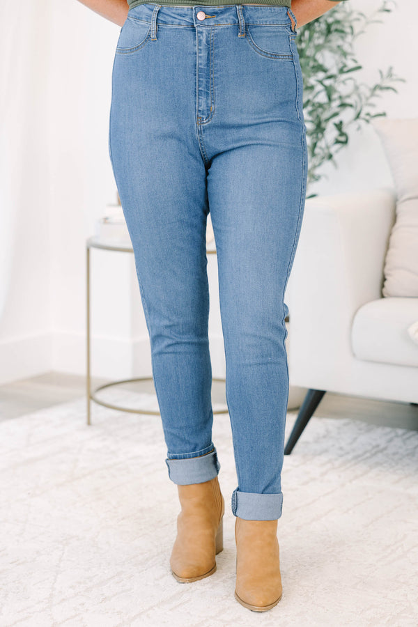 Plus size high-rise skinny jeans in denim blue with cuffed ankles and stretchy fabric.