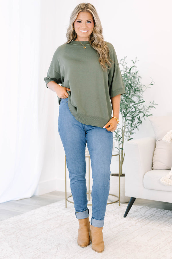 Plus size high-rise skinny jeans in denim blue with cuffed ankles and stretchy fabric.